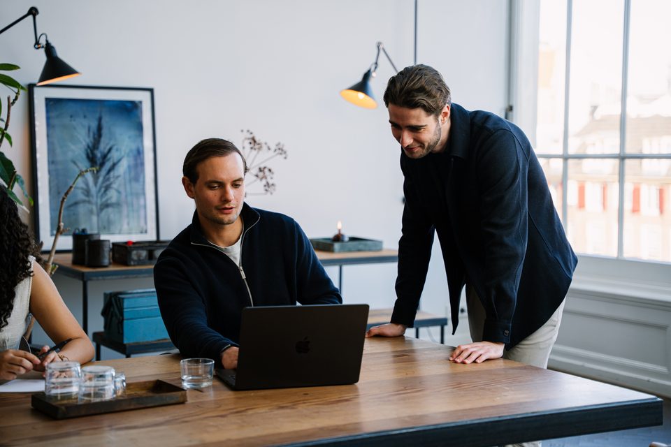 Entrepreneur and adviser reviewing the bookkeeping together on a laptop