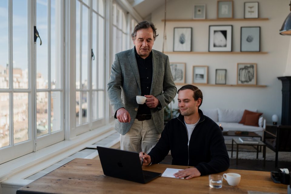 Entrepreneur and adviser reviewing the bookkeeping together on a laptop