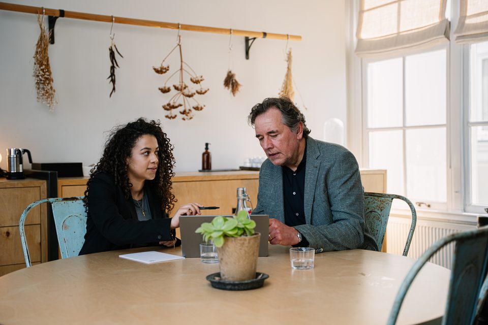 Adviser and entrepreneur in discussion at the meeting table