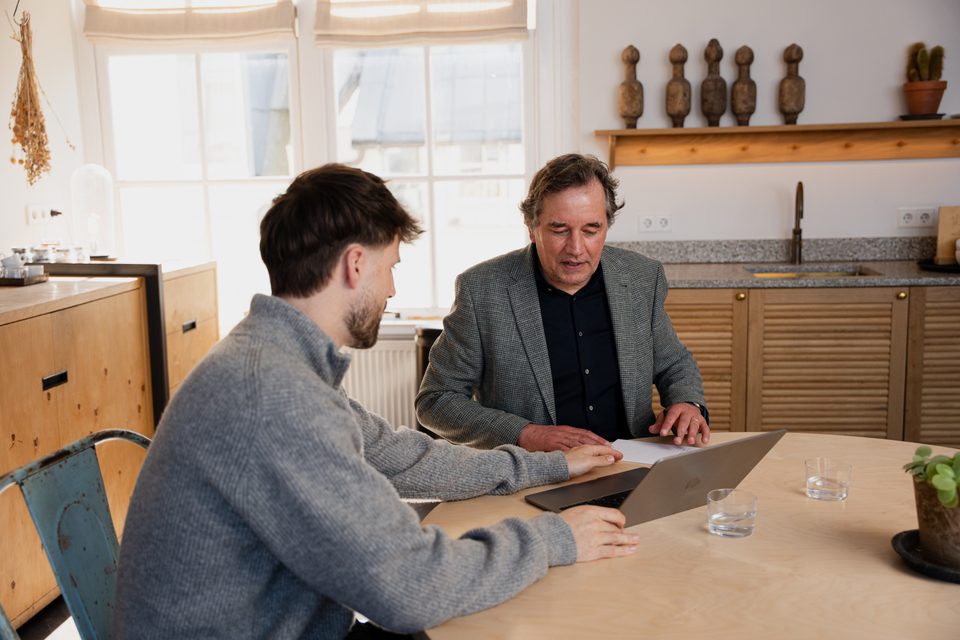 Entrepreneur and adviser reviewing the bookkeeping together on a laptop
